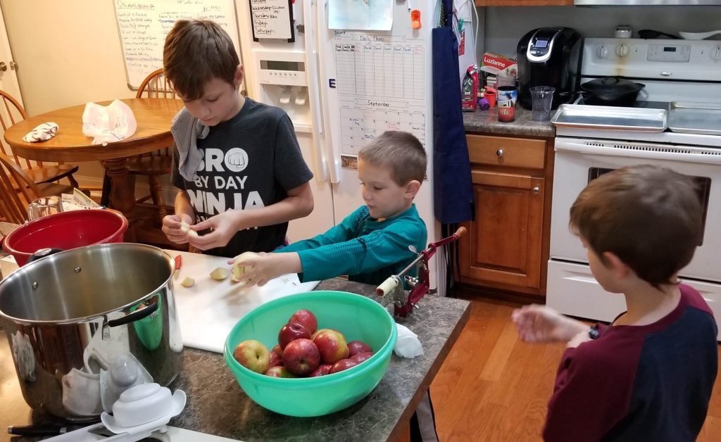 homeschooling while helping in the kitchen, making applesauce