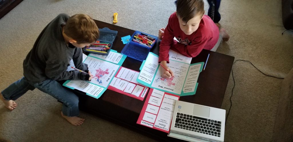 Homeschool can happen all over the house. Here we are working on the coffee table in the living room.